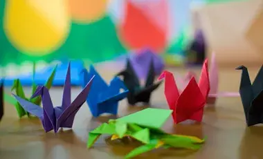 Colorful origami cranes placed on a table