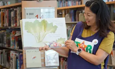 star reader holding a book