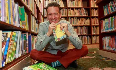 a man in a library with books