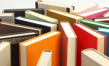 Books standing on end arranged randomly.