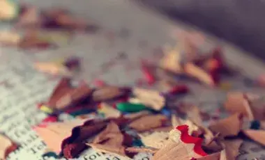 colored pencil shavings on a book page