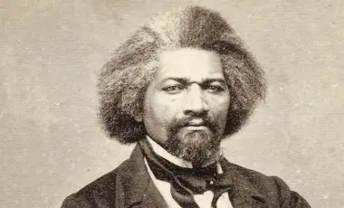 Black and white photo of Frederick Douglass in 19th century suit 