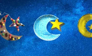 Three crescent moons connected to paper stars made out of paper plates. 