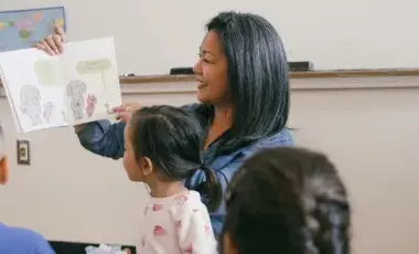 Librarian reading aloud to children  