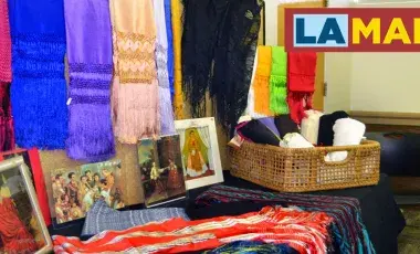 colorful rebozos on display in a library