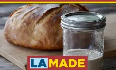 close up of sourdough loaf and starter