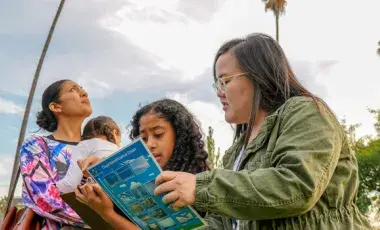 kids participating in a cloud identification class outside the library