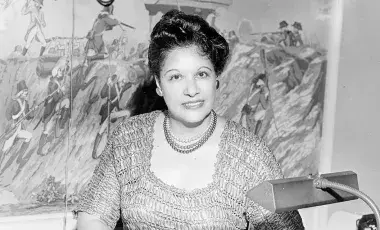 woman poses at desk 