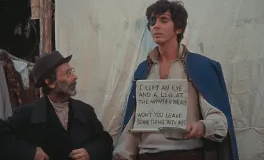 film scene beggar holding sign asking for donation 