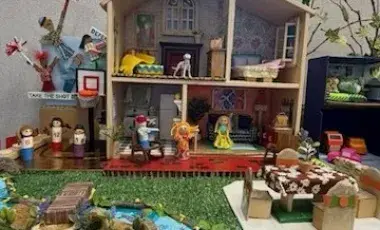 A homemade dollhouse made of upcycled craft materials