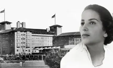 Profile image of a pretty woman with dark hair in front of the Ambassador Hotel. 