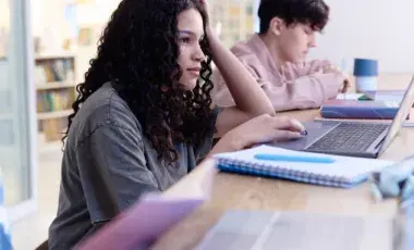  students studying and using laptops