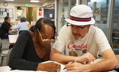 Tutor working with adult learner.