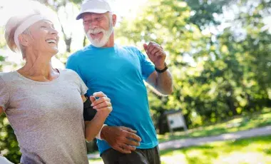 older couple jogging with man wearing a blue shirt and woman wearing a white shirt