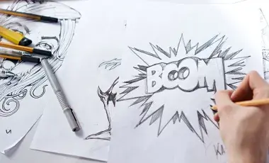 Close-up of hand drawing various graphic/comic sketches