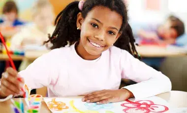 A young girl painting 