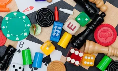 a close up of a variety of game pieces on top of a chess board