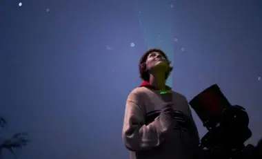 Astronomer Casey Cooper looks up at the night sky.
