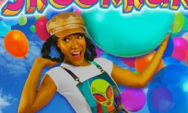 woman in a hat surrounded by colorful balloons