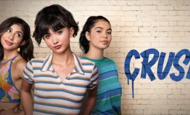 Three young women stand confidently against a white brick wall. The word "CRUSH" is painted in bold, blue letters. 