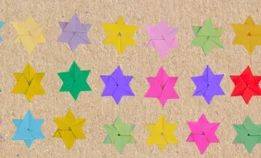 Paper Star of David origami in multiple colors on a brown background