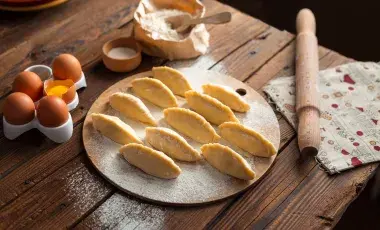 eleven empanadas on a round board