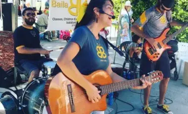 woman singing with a guitar