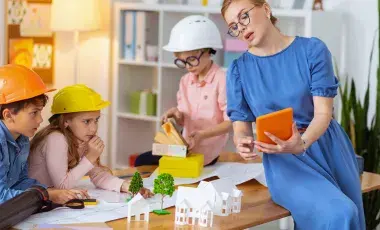 A woman and three children engage in an architecture-theme activity.