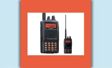 Two black HAM radios with orange screens and antennae sit next to each other on a white background.