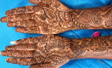 Image of two hands painted with Henna