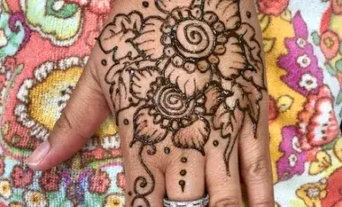 A hand with a henna design by artist Katy DeBra