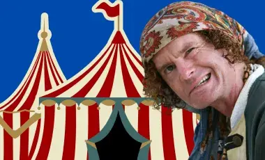 Christopher Yates in front of a white and red stripped circus tent