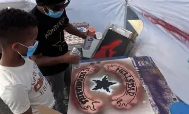 Spray painting a sign