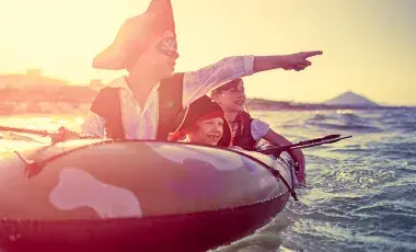 Kids in a rubber boat dressed like pirates