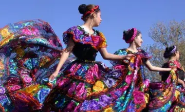 Four dancers perform the Mexican folk dance "baile folklórico" outdoors