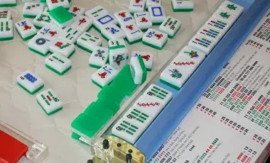 Image of the game of Mah Jongg tiles in mid-game.