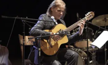 A man playing a guitar.