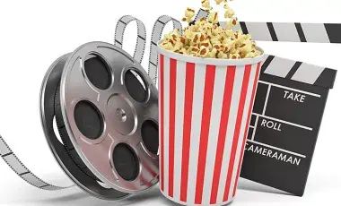 Photo consists of movie film role, popcorn, and director's marker.