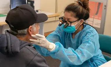 health care professional conducting an oral health exam