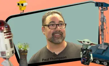 A man framed by two robots from entertainment. 