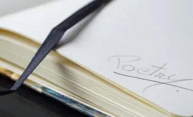 Close-up of a page in a journal with the word poetry written in it.