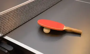 Ping Pong racket on table with net