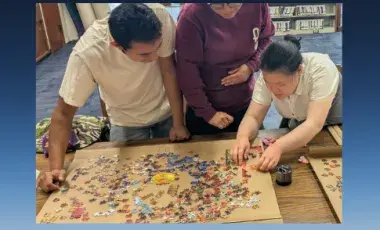 People working on a puzzle