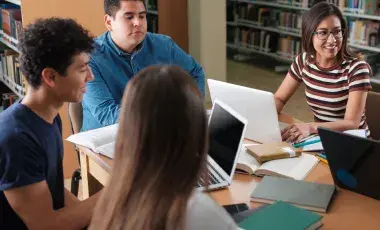 teens sitting around table talking