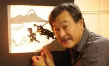 An artist shows off his shadow puppet creations