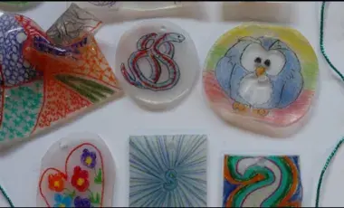 image of a number of shrinky dink amulets laid out on a white background