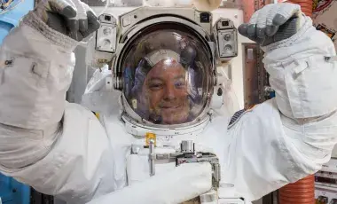 NASA astronaut Scott Tingle wears a U.S. spacesuit inside the Quest Airlock preparing for his first spacewalk