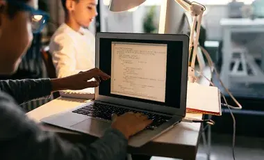 Boys on laptops coding