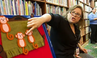 Librarian pointing to felt board during Storytime