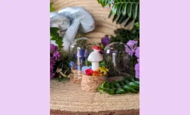 tiny crystal mushroom surrounded by flowers and glass terrariums